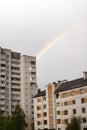Rainbow in the gray sky over the rooftops Royalty Free Stock Photo