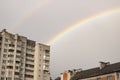 Rainbow in the gray sky over the rooftops Royalty Free Stock Photo