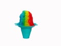 Rainbow Hawaiian Shave ice, Shaved ice or snow cone in a blue flower shaped cup against a white background. Royalty Free Stock Photo