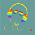 Rainbow headphones with cord in shape of hand with sunglasses. Royalty Free Stock Photo