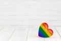 Rainbow heart shaped on white wood background with copy space Royalty Free Stock Photo