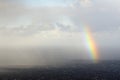 Rainbow in heavy clouds Royalty Free Stock Photo