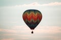 Rainbow hot air balloon flying through the sky at sunset in Michigan