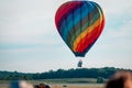Rainbow hot air balloon landing during an airshow