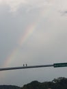 Rainbow at intersection while driving on a cloudy  day Royalty Free Stock Photo