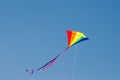 Rainbow kite design flying on blue sky. Royalty Free Stock Photo