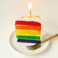 Rainbow  layered cake slice with candle Royalty Free Stock Photo