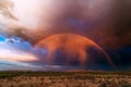 Rainbow and monsoon storm at sunset Royalty Free Stock Photo