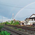 rainbow in the morning over the railroad tracks after it rained Royalty Free Stock Photo