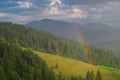 Rainbow in the mountain valley after rain. Beautiful landscape. Royalty Free Stock Photo