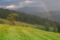 Rainbow in the mountain valley after rain. Beautiful landscape. Royalty Free Stock Photo