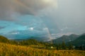 Rainbow in the mountain valley after rain. Beautiful landscape. Royalty Free Stock Photo