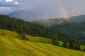 Rainbow in the mountain valley after rain. Beautiful landscape. Royalty Free Stock Photo