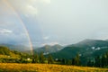 Rainbow in the mountain valley after rain. Beautiful landscape in Carpathians. Ukraine Royalty Free Stock Photo