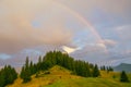 Rainbow in the mountain valley after rain. Beautiful landscape in Carpathians. Ukraine Royalty Free Stock Photo