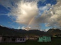 Rainbow in mountains , coming through the dramatic clouds in uttarakhand chamoli Royalty Free Stock Photo