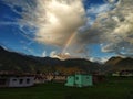 Rainbow in mountains , coming through the dramatic clouds in uttarakhand chamoli Royalty Free Stock Photo