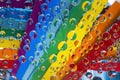 Rainbow. Multicolored drops of water are located against a background with strips of rainbow colored paper. Royalty Free Stock Photo