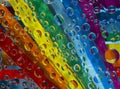 Rainbow. Multicolored drops of water are located against strips of rainbow colored paper. Royalty Free Stock Photo