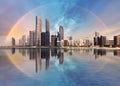 Rainbow over Abu Dhabi skyline with reflection in sea, United Arab Emirates - panorama