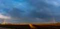 Rainbow over agrigulture fileds in dramatic sky Royalty Free Stock Photo