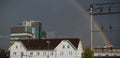 Rainbow over baar city tower train station blue house