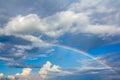 Rainbow over blue sky with clouds. Royalty Free Stock Photo