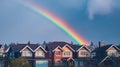 Rainbow over the city, urban landscape after rain, rainbow arc in the sky. Royalty Free Stock Photo