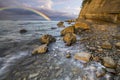 Rainbow over the cliff after passing an evening storm Royalty Free Stock Photo