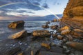 Rainbow over the cliff after passing an evening storm Royalty Free Stock Photo