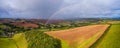 Rainbow over Compton Castle Village and Meadows from a drone, Devon, England