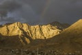Rainbow over the desert mountains in the dark evening sky Royalty Free Stock Photo