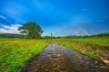 Rainbow over fields and trees and river Royalty Free Stock Photo