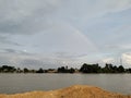 The rainbow over the flowing river and the view of the house that makes the tower soaring nostalgia Royalty Free Stock Photo