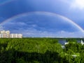 Rainbow over forest and calm lake water in Moscow. general plan Royalty Free Stock Photo