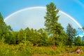 Rainbow over the forest on a summer evening Royalty Free Stock Photo