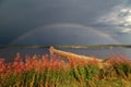 Rainbow over Fornby pier at SiljansnÃÂ¤s, Sweden Royalty Free Stock Photo