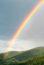 Rainbow over green hills