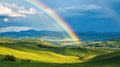 Rainbow over green hills and valleys Royalty Free Stock Photo