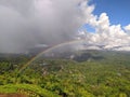Rainbow over the hill during the day Royalty Free Stock Photo