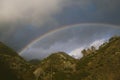 Rainbow over hills after storm