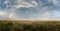 Rainbow over the landscape of the Serengeti, Tanzania Royalty Free Stock Photo