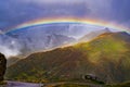 Rainbow over the majestic mountains of the alpine high road Timmelsjoch on way from Tyrol, Austria, to Merano in South Tyrol Italy