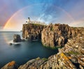 Rainbow over Neist Point Lighthouse on the green cliffs of the Isle of Skye, Scotland Royalty Free Stock Photo