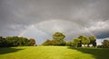 Rainbow over an orchard in summer Royalty Free Stock Photo