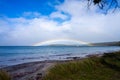 rainbow over the ovean and above an island Royalty Free Stock Photo