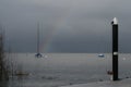 Rainbow over a sailboat during storm