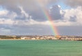 Rainbow over Saint Helier capital city with sea in the foreground, bailiwick of Jersey, Channel Islands, UK