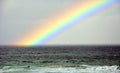 Seascape with beautiful multicoloured rainbow over the sea