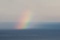 Rainbow over sea water Royalty Free Stock Photo